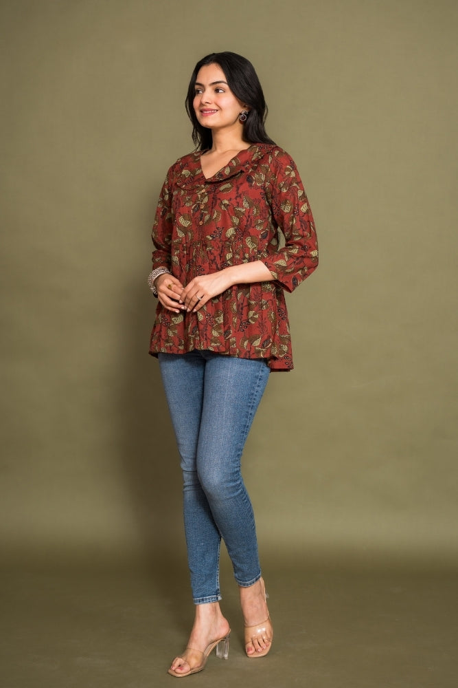 Model wearing Ekisha's women maroon floral kalamkari designer printed cotton tunic top short kurti, side view