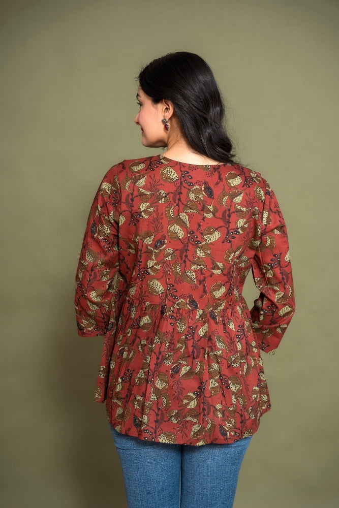 Model wearing Ekisha's women maroon floral kalamkari designer printed cotton tunic top short kurti, back view