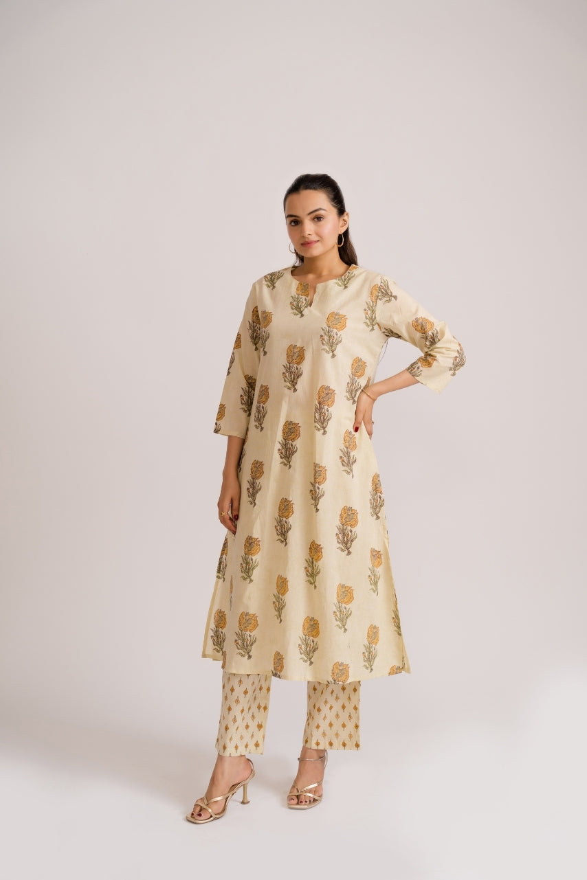 Women wearing cream A-line kurti with mustard buta block print and contrast diamond pants – Ekisha