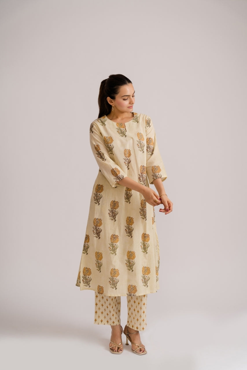 Close-up of mustard floral buta block print motif on cream cotton fabric – Ekisha