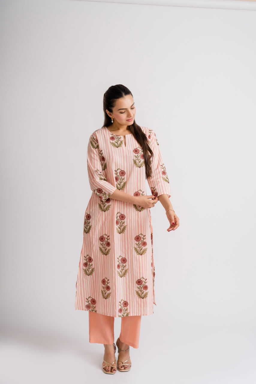 Close-up of marigold dusty rose floral buta block print on peach stripe cotton – Ekisha