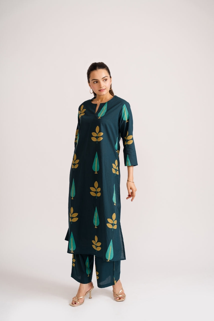 Close-up of gold leaf and teal cypress tree block print motif on deep teal cotton – Ekisha