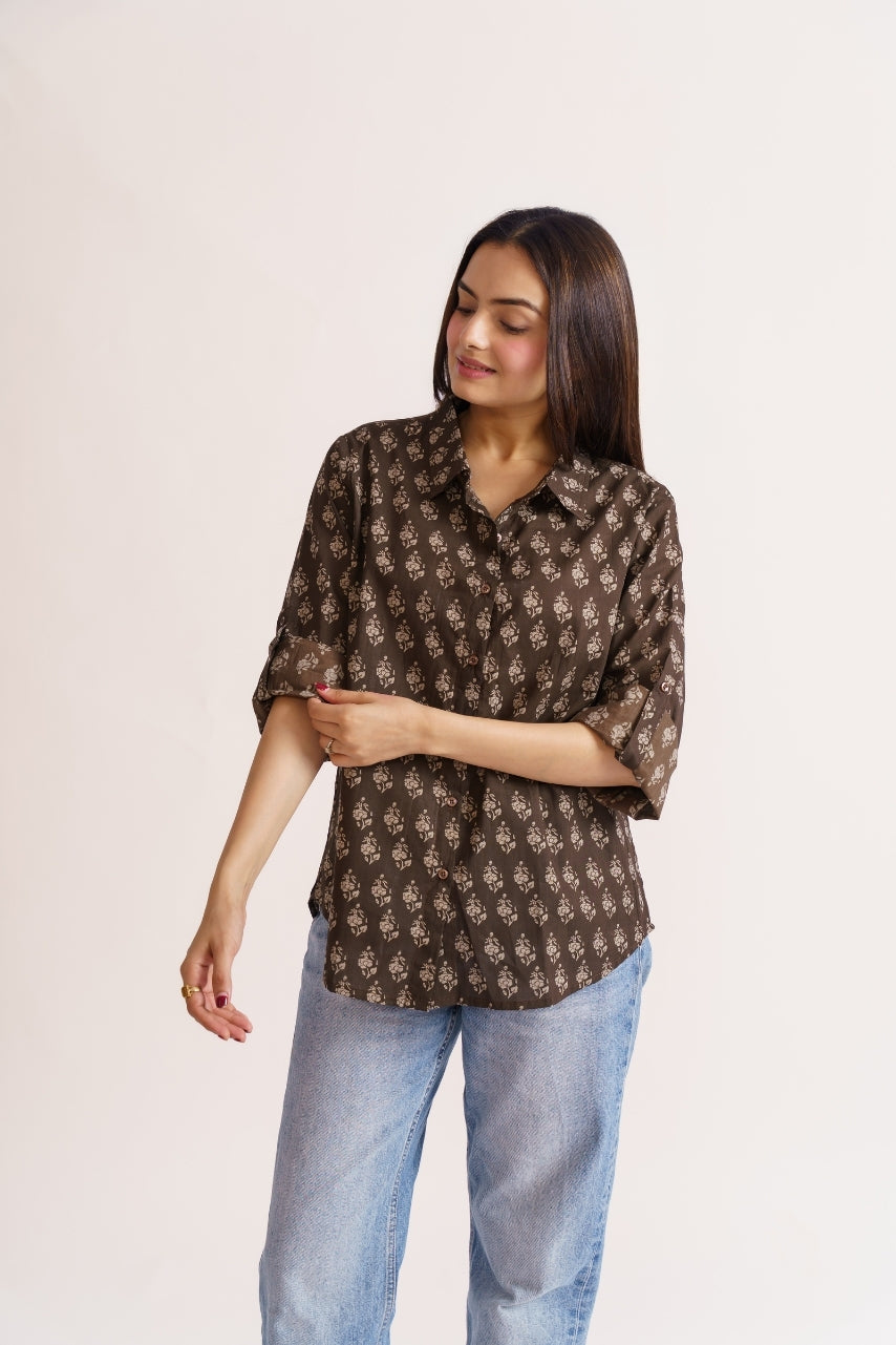 Woman wearing brown floral print cotton button-down shirt with jeans