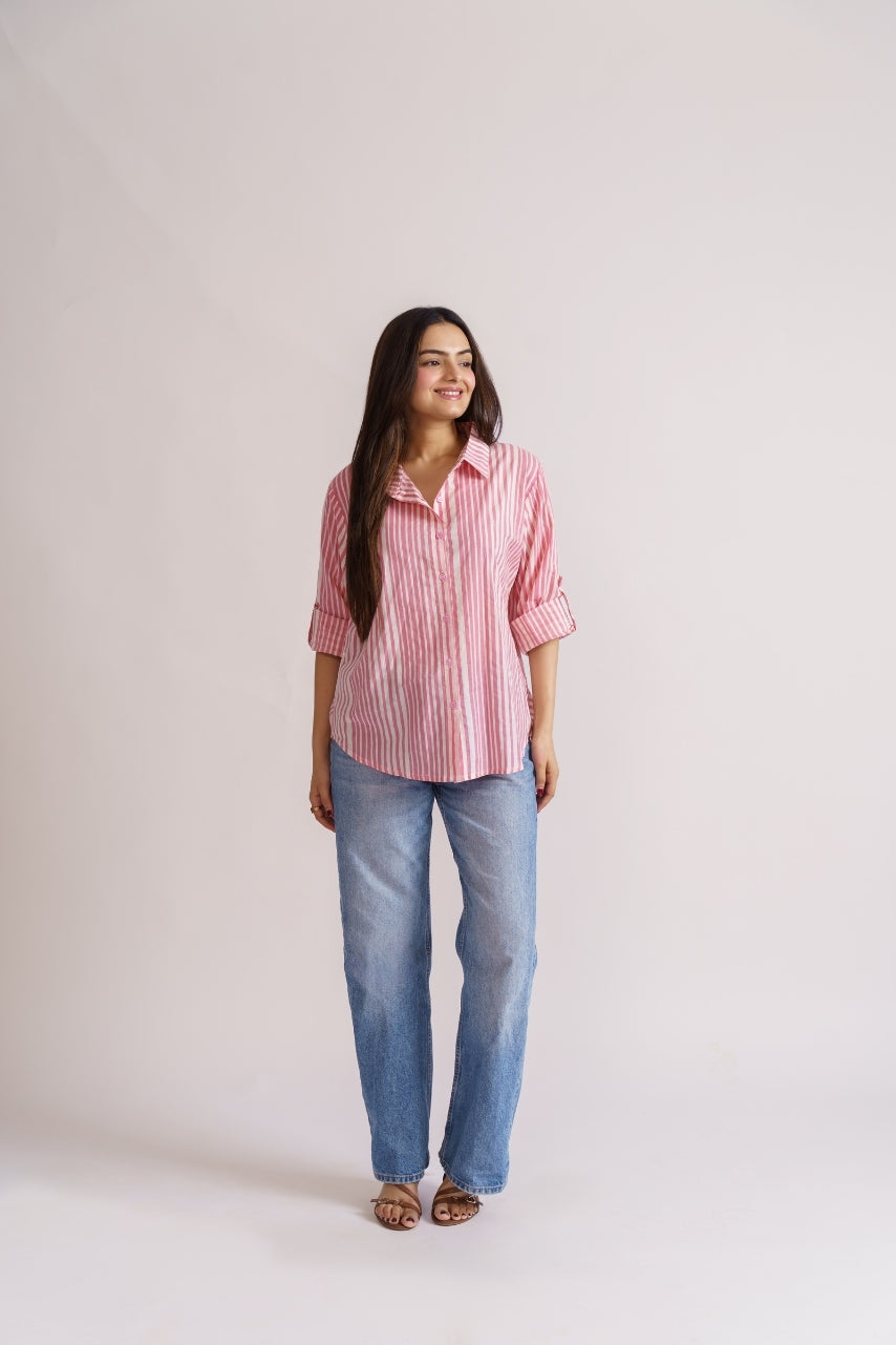 Woman wearing pink stripe cotton button-down shirt with jeans