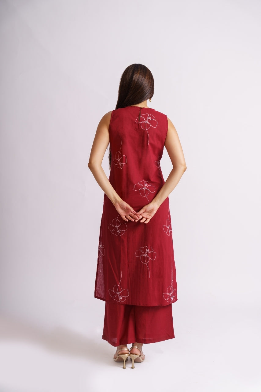 Close-up of cream line-art floral print on maroon fabric