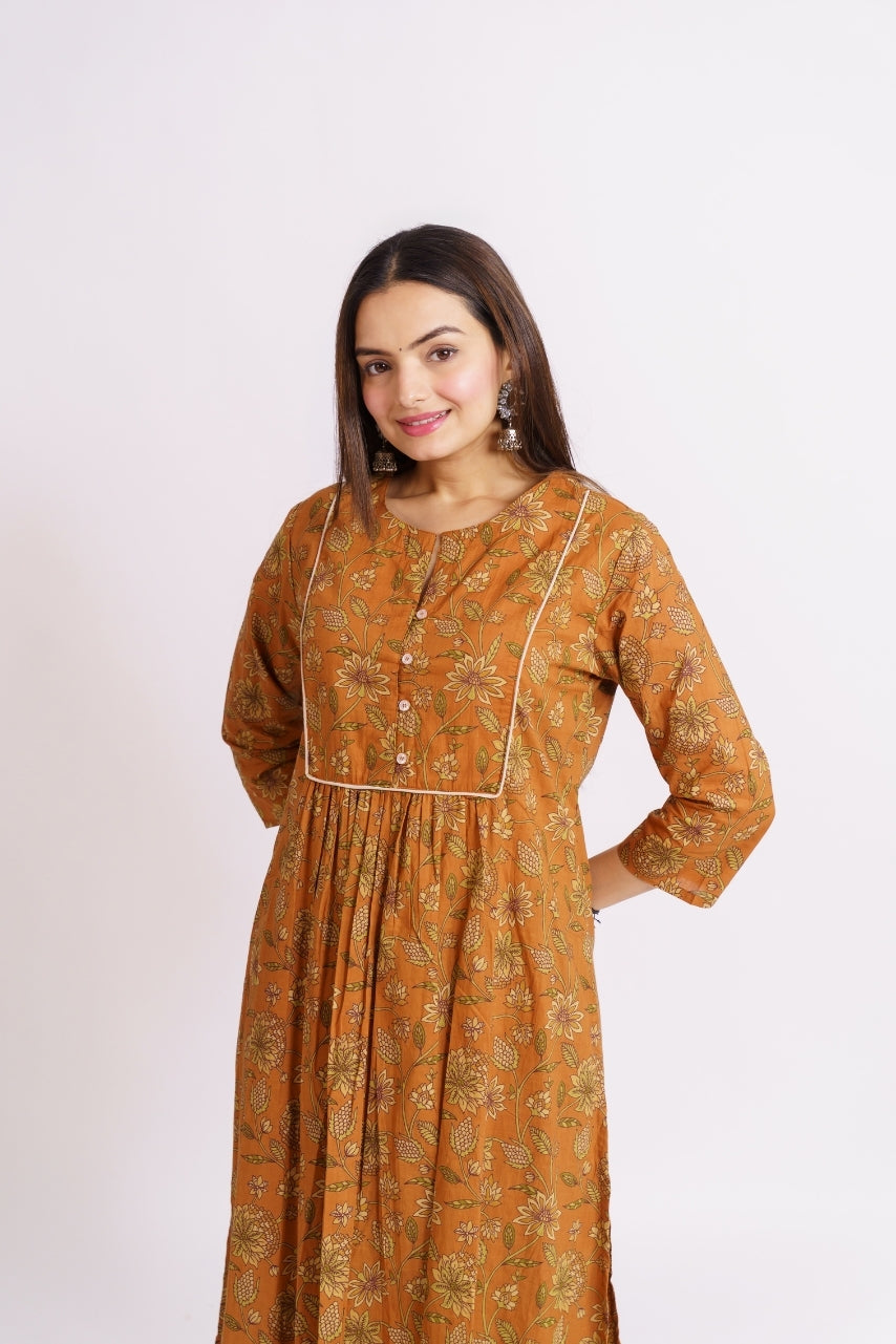 Close-up of green floral print on mustard cotton kurta
