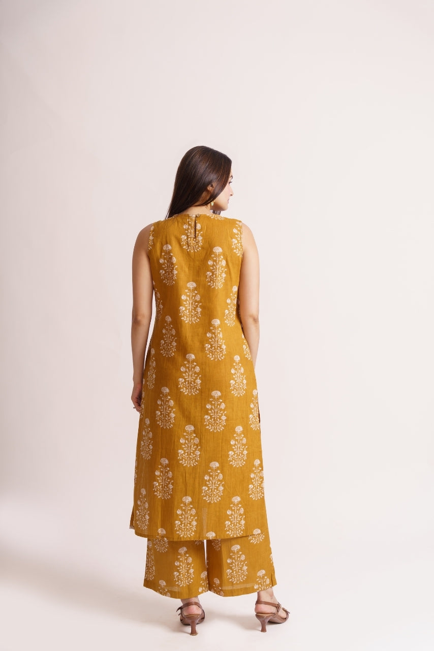 Close-up of white booti floral print on mustard cotton fabric