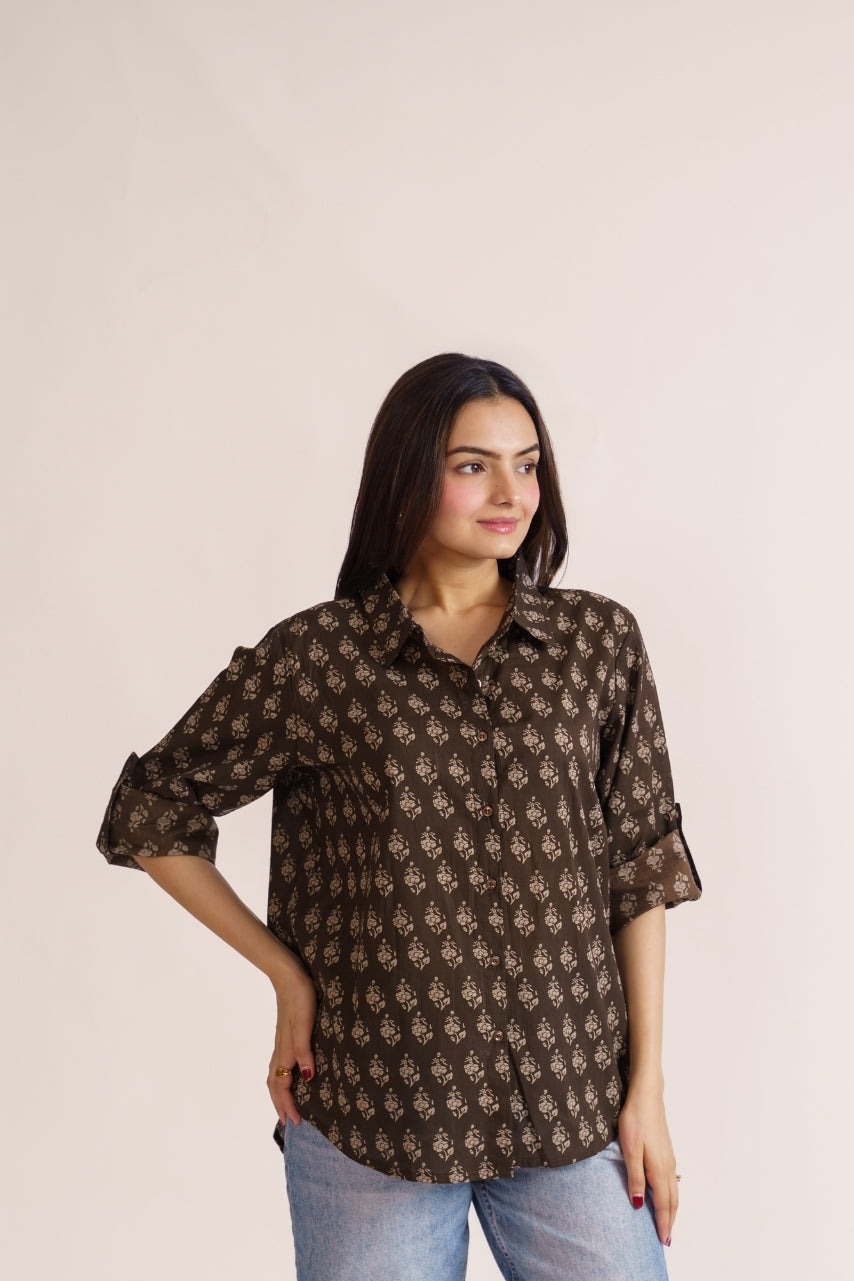 Brown botanical print button-down paired with straight-leg jeans