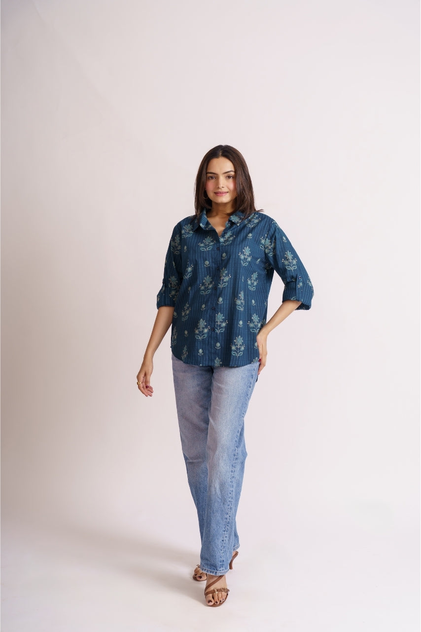 Woman wearing teal floral print cotton button-down shirt with jeans