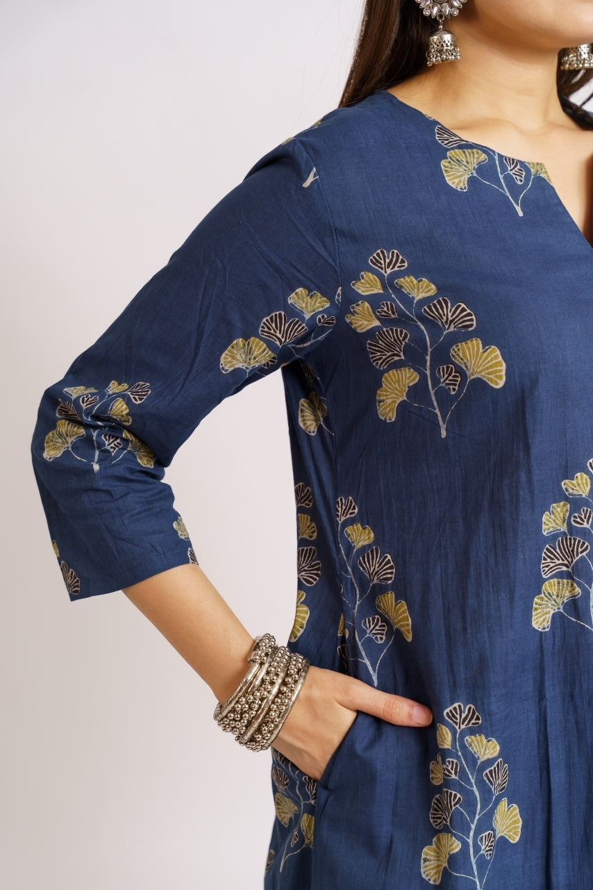 Close-up of mustard ginkgo leaf print on navy cotton kurta