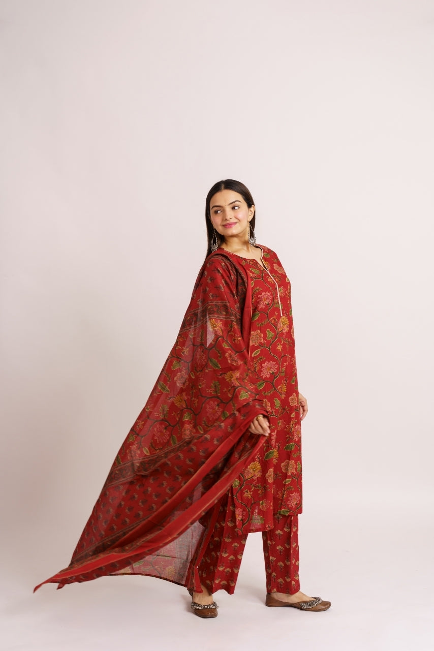 Woman draping floral print cotton dupatta over red kurta set