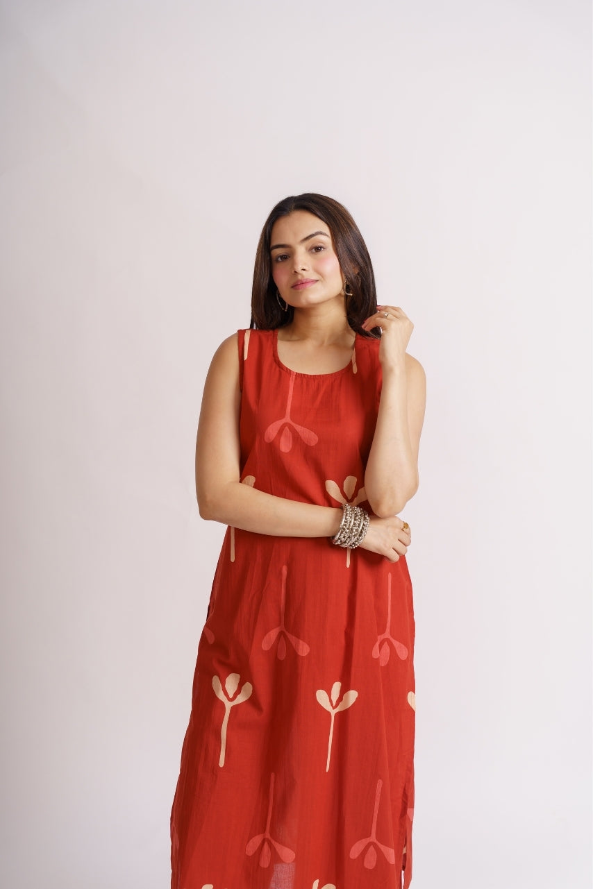 Model wearing full-length rust red palazzo set, standing pose