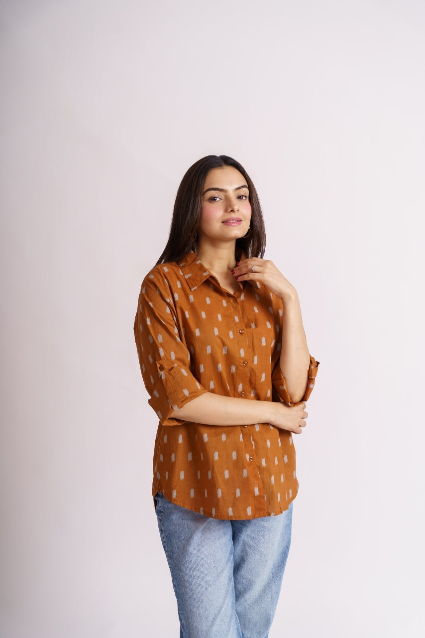Model wearing oversized rust ikat print shirt, front pose