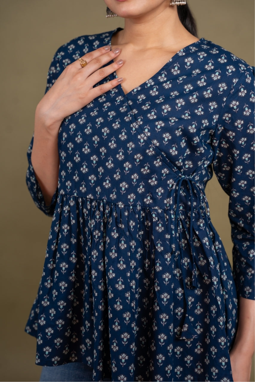 Navy blue dress with floral pattern worn by a person against a brown background