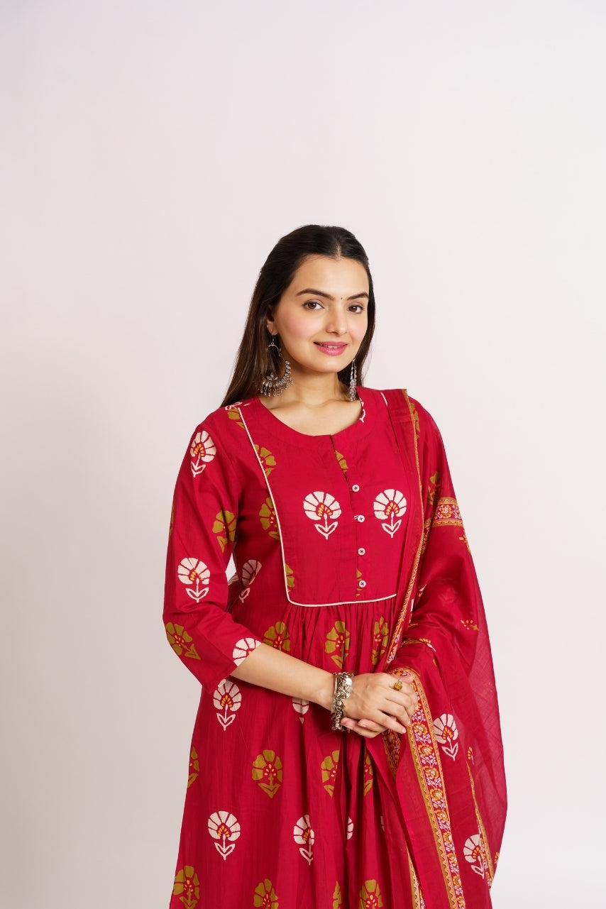 Woman draping printed border dupatta over crimson kurta set