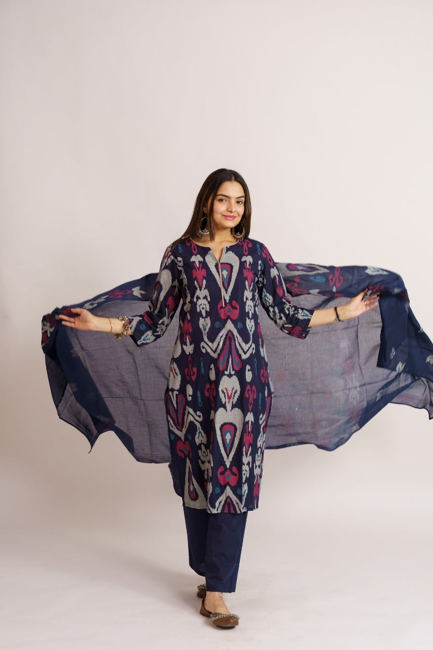 Woman draping ikat print cotton dupatta over navy kurta set