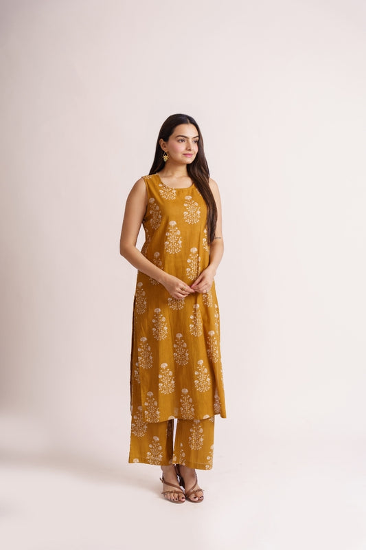 Woman wearing mustard yellow floral print sleeveless kurta set, side view