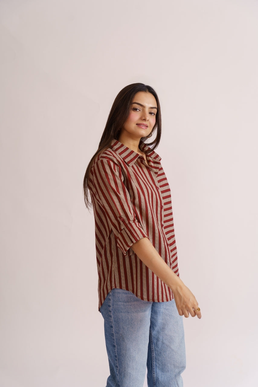 Model wearing oversized maroon stripe shirt, full-body pose