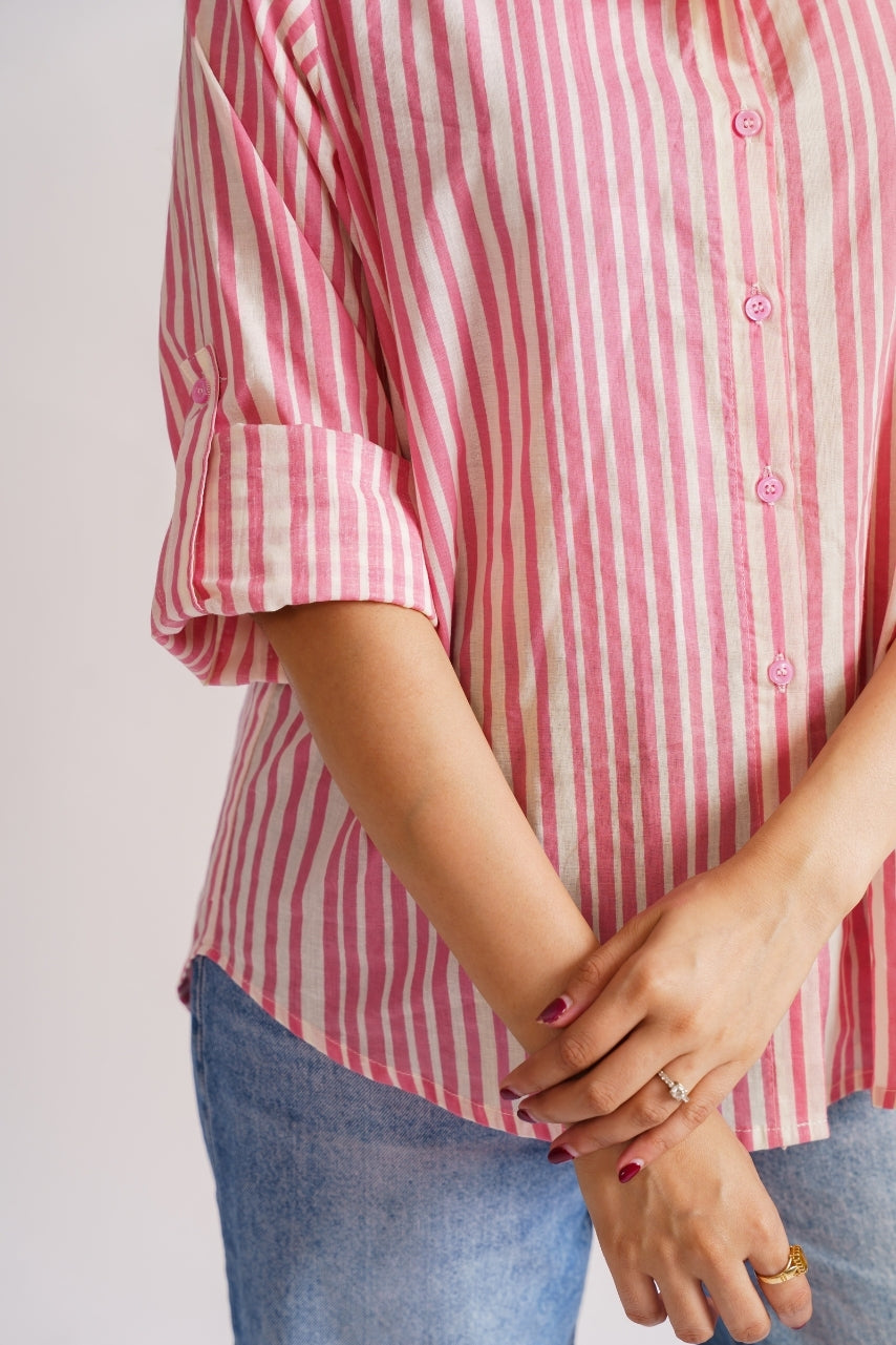 Pink and white striped button-down paired with jeans