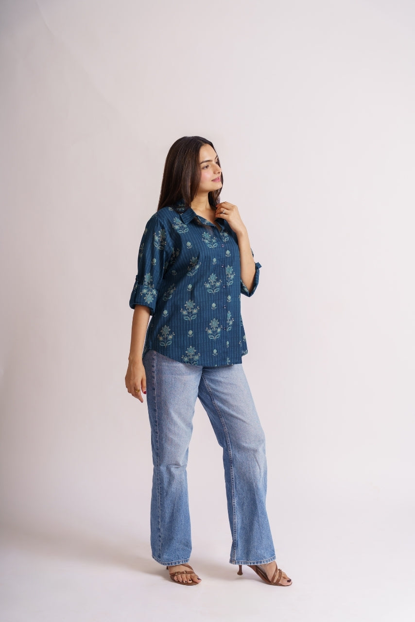 Model wearing oversized teal floral shirt, front pose