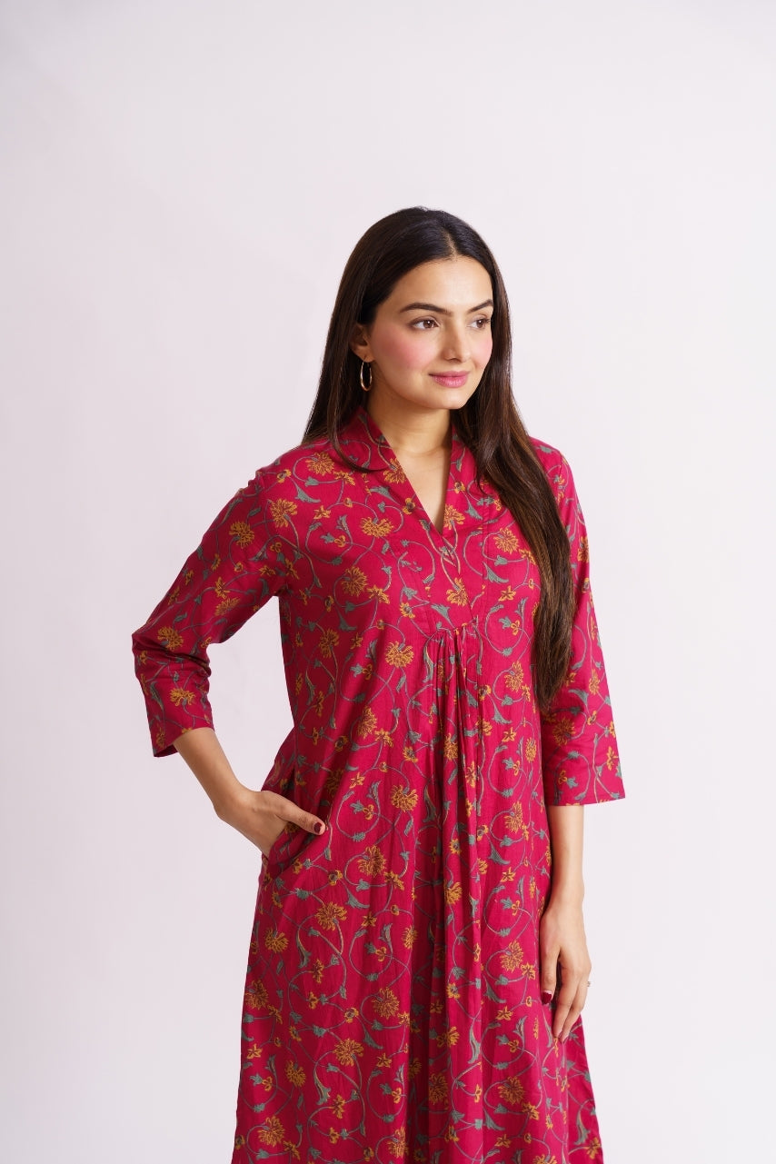 Model wearing full-length magenta floral kurti, standing pose